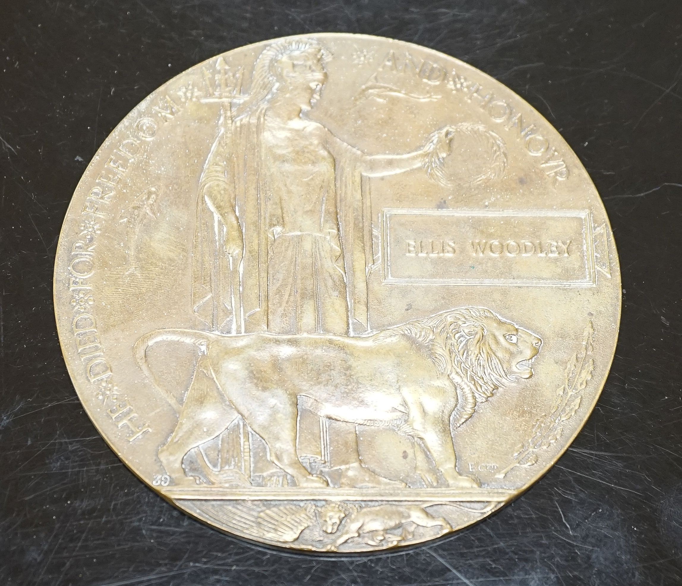 A WWI bronze death plaque to Ellis Woodley